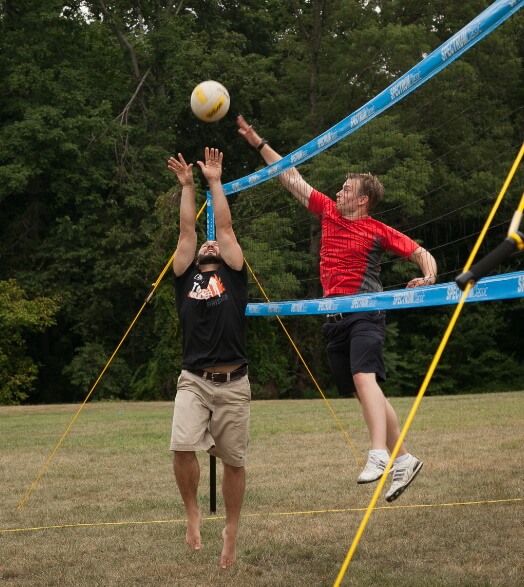 Two men playing volleyball
