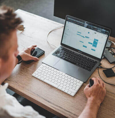 Man sitting at desk with laptop